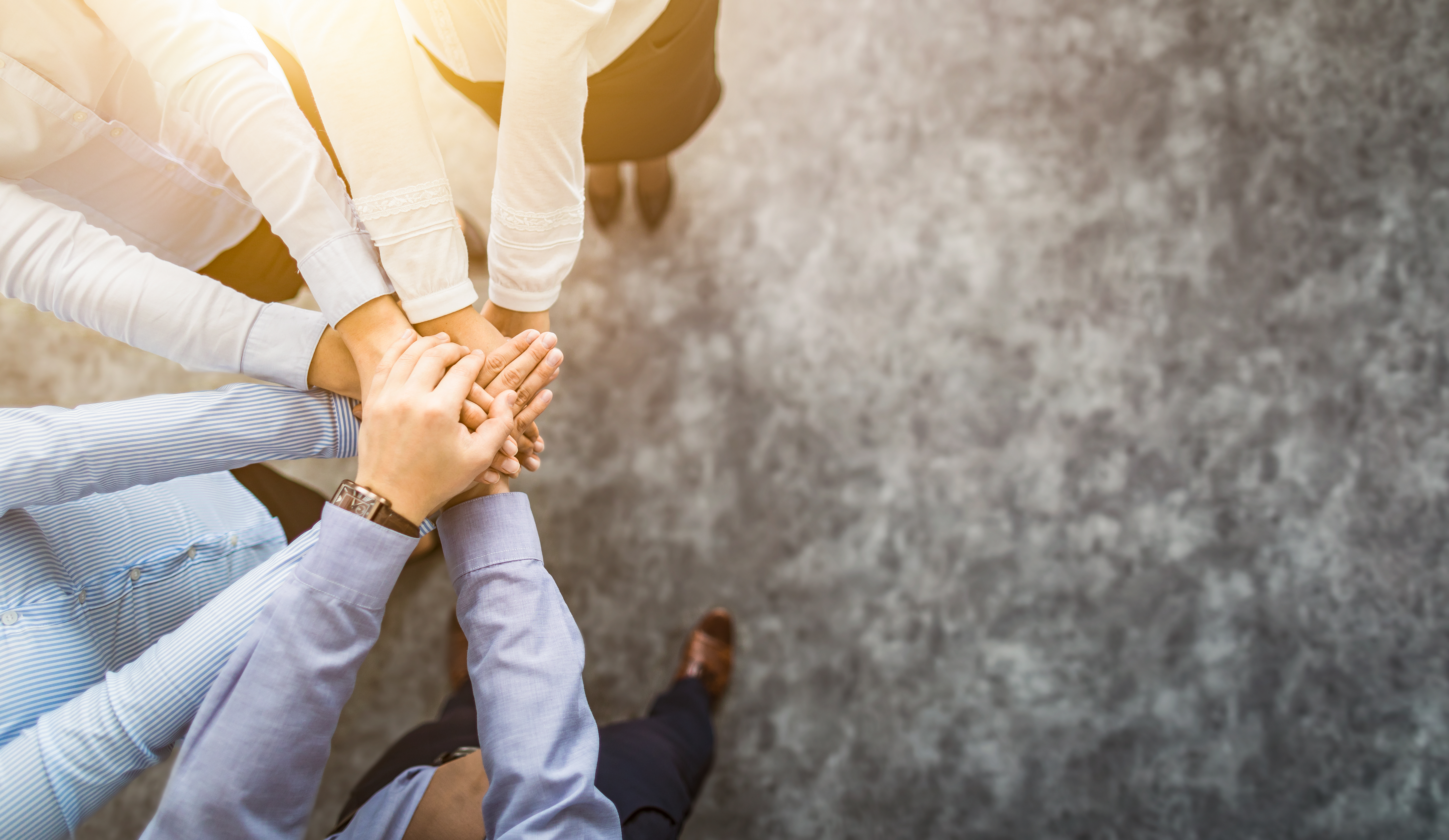 group of people putting their hands together